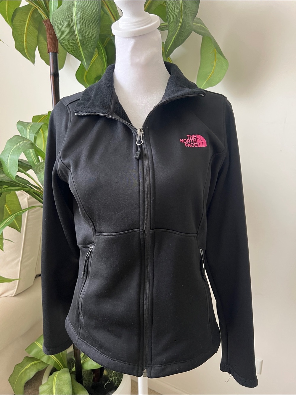 The North Face Womenโs Black Jacket with Pink Logo